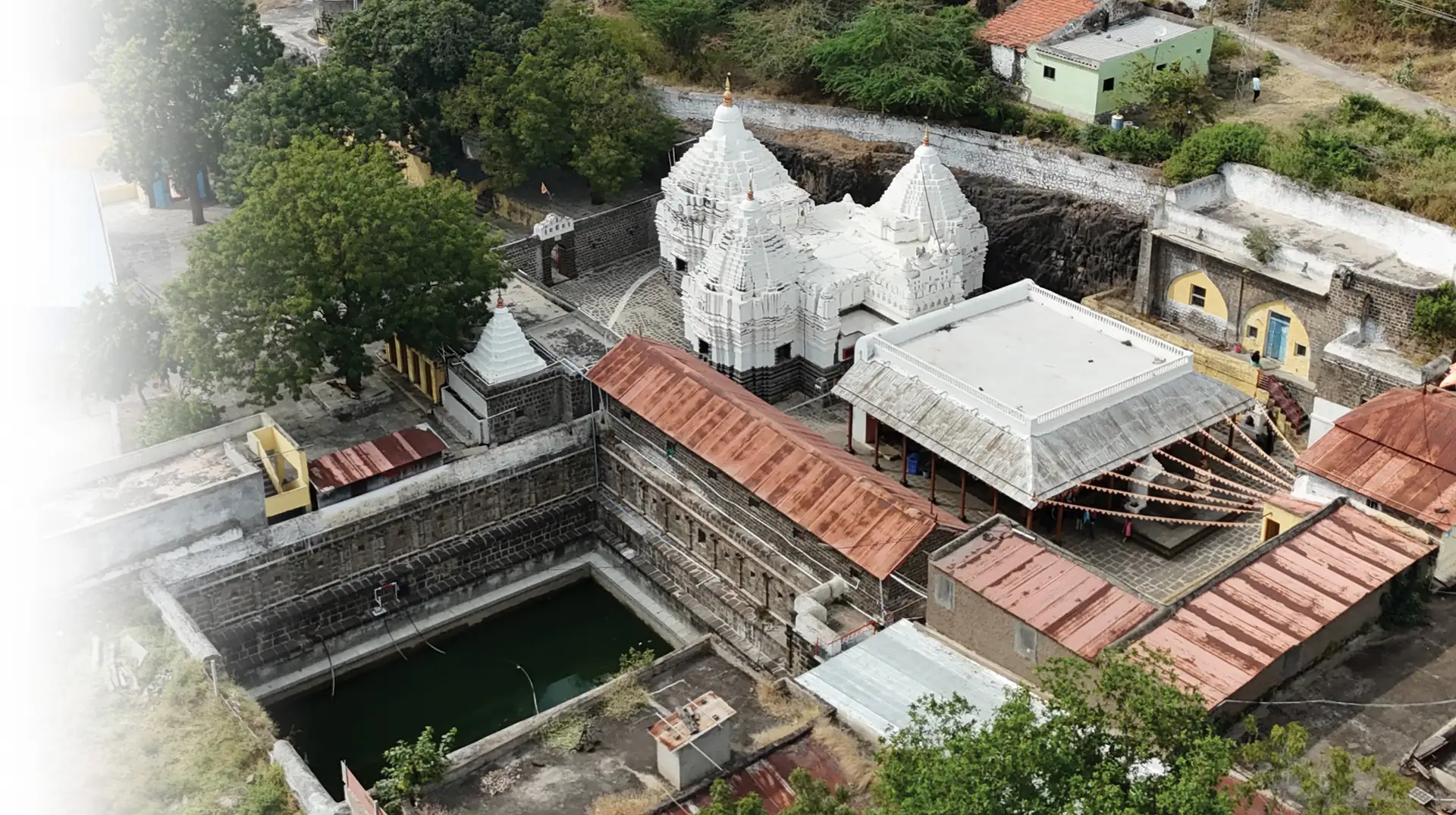 The white shikharas and stepped tank of Raamtheerth seen from above