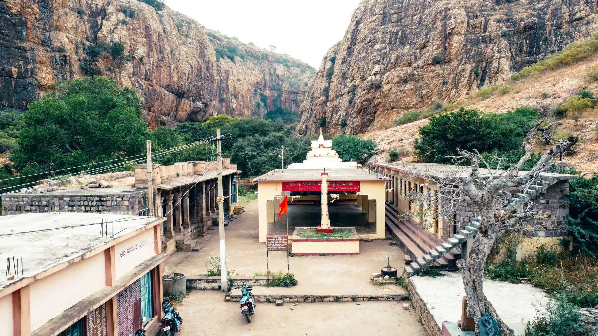 Sheer rock cliffs rising above the temple settlement at Shabari Valley